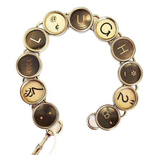 Typewriter Key Bracelet that spells LAUGH